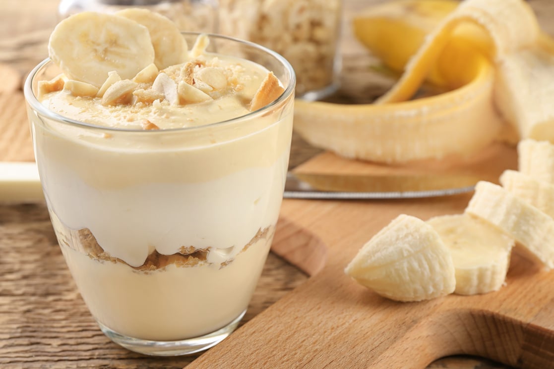 Glass with Delicious Banana Pudding on Table