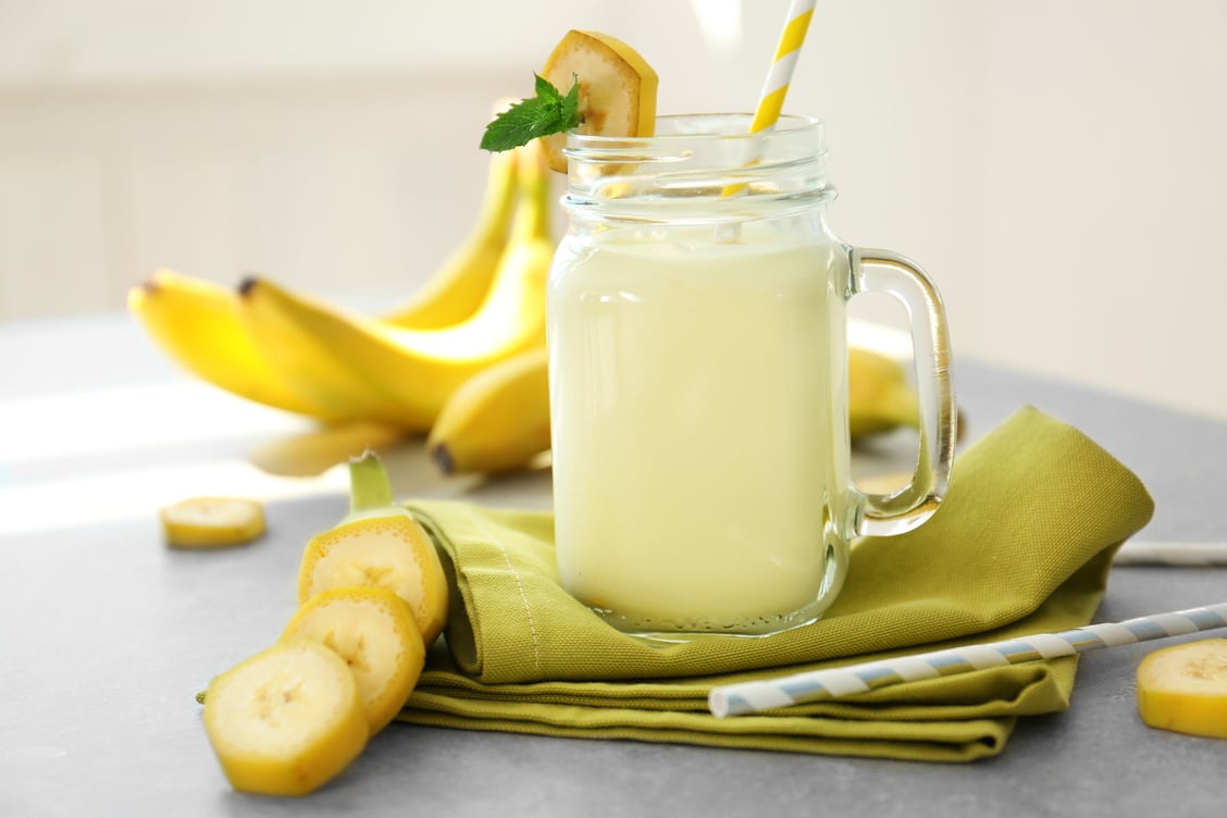 Jug with Banana Milk on Table