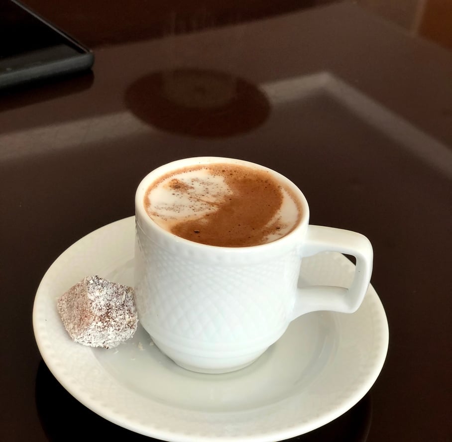 Turkish coffee with milk and traditional sweet delight