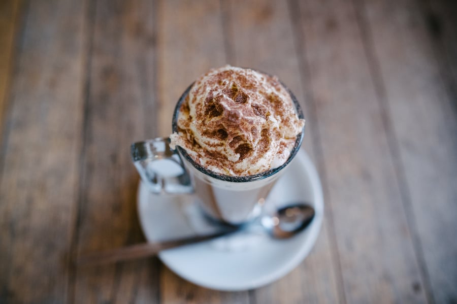 Coffee with Cream and Chocolate on Wooden Surface